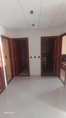 an empty room with two doors and a room with a toilet at Résidence yassine in Rabat