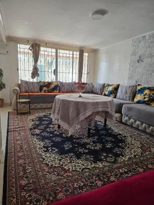 a living room with a couch and a table at Appartement villa in Temara