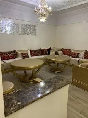 a living room with two tables and a couch at الدروة in Derroua