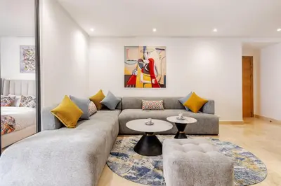 a living room with a couch and a table at 2 - Bourgogne City Escape in Casablanca