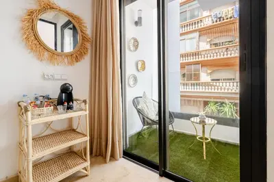 a room with a balcony with a mirror and a chair at 2 - Bourgogne City Escape in Casablanca
