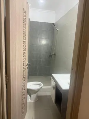 a bathroom with a toilet and a sink at Appartement Sidi Rehal beach in Sidi Rahal