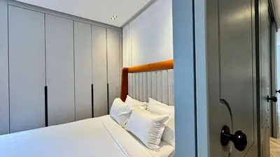 a bedroom with a bed with white sheets and pillows at Urban Apartment 2 Mars - By AppartAli in Casablanca