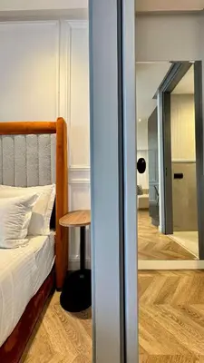 a bedroom with a bed and a table and a mirror at Urban Apartment 2 Mars - By AppartAli in Casablanca