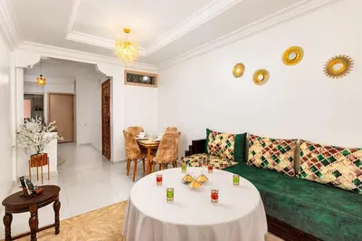 a living room with a couch and a table at Bright apartment Maarif, 2 bedrooms, Wi-Fi, AC in Casablanca