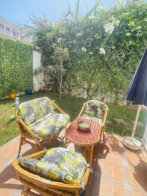 a patio with two chairs and a table with at Stunning Sunny Villa, near airport in Derroua