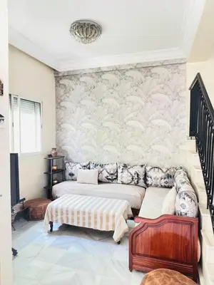 a living room with two beds and a couch at Stunning Sunny Villa, near airport in Derroua
