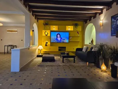 a living room with a couch and a tv on a wall at Marrakech atmosphere in Casablanca in Casablanca