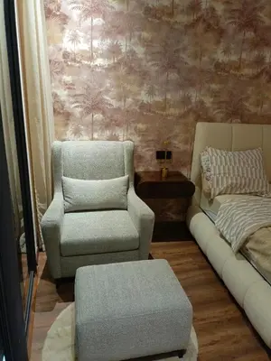 a living room with a couch and a chair at Palmier house for family only in Maarif