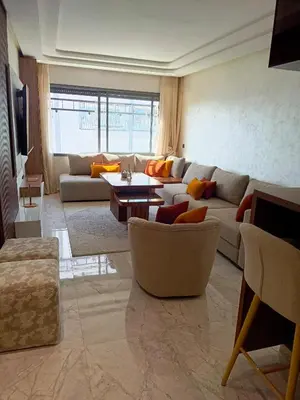 a living room with a couch and a table at Palmier house for family only in Maarif