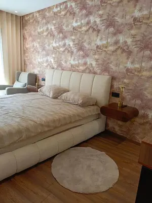 a bedroom with a large white bed and a couch at Palmier house for family only in Maarif