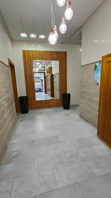 a large room with a large door and a tile floor at Bel appartement in Casablanca