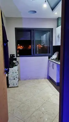a kitchen with a counter and a large window at Bel appartement in Casablanca