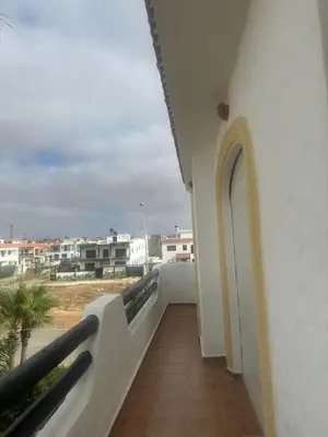 a balcony with a view of a building at New and cosy appt for rent in Sidi Rahal