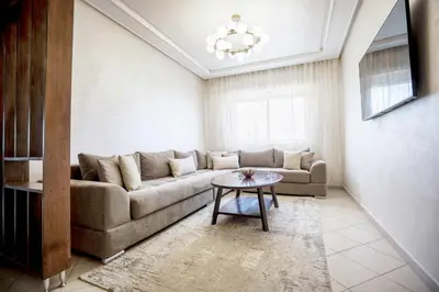 a living room with a couch and a table at Cozy Apartment in the Heart of Bouznika in Bouznika