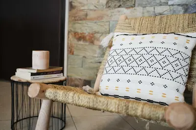 a pillow sitting on a chair in a room at Cozy Apartment in the Heart of Bouznika in Bouznika