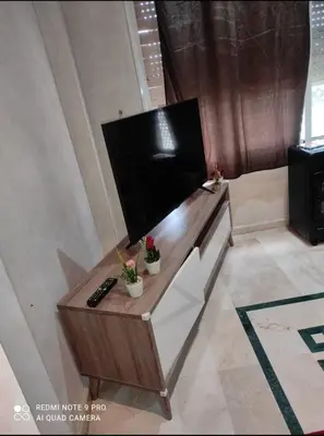 a living room with a table with a television at اقامة فال دانفا in Casablanca
