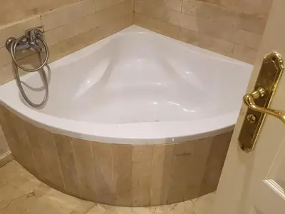 a bath tub in a bathroom with a door at اقامة فال دانفا in Casablanca