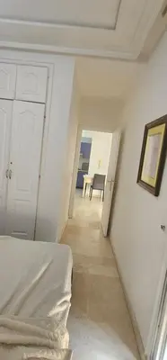 a white room with a bed and a table at اقامة فال دانفا in Casablanca