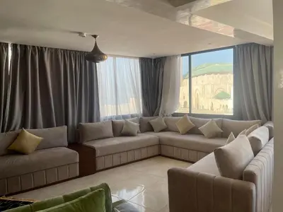 a living room with a couch and a large window at Spacious Apartment with Panoramic Ocean Views in Casablanca
