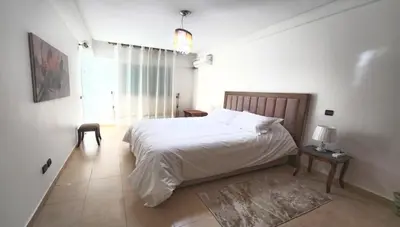 a bedroom with a white bed and a window at Serenity in Rabat's downtown in Rabat