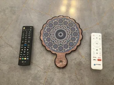 a table with two remote controls and a table with a plate at Serenity in Rabat's downtown in Rabat