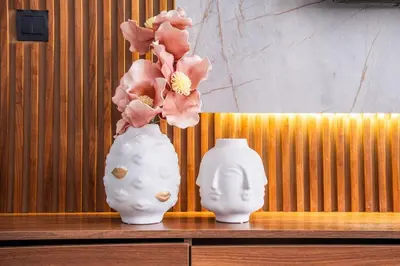 two white vases sitting on a wooden table with flowers at Terracotta Chic Studio Cosy Les Princesses Casablanca in Casablanca