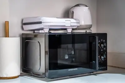a printer sitting on top of a microwave at Terracotta Chic Studio Cosy Les Princesses Casablanca in Casablanca