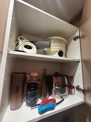 a cabinet filled with dishes and other kitchen items at Appartement 2 chambres a coucher dans un residence securise au centre Mohamadia in Mohammedia