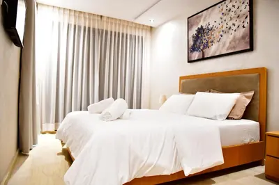 a bedroom with two beds with white sheets at Le Supreme Chic in Casablanca