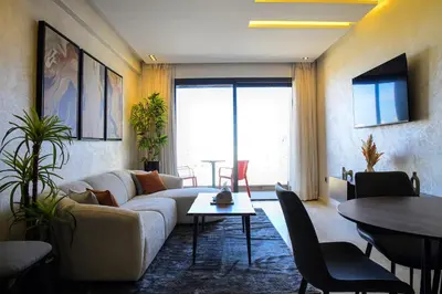 a living room with a couch and a table at Le Supreme Chic in Casablanca