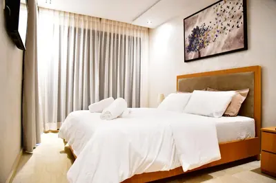 a bedroom with two beds with white sheets at Le Supreme Chic in Casablanca