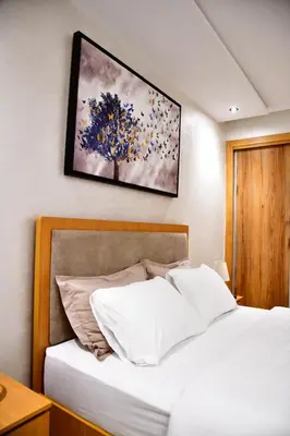 a bedroom with a bed and a painting on the wall at Le Supreme Chic in Casablanca