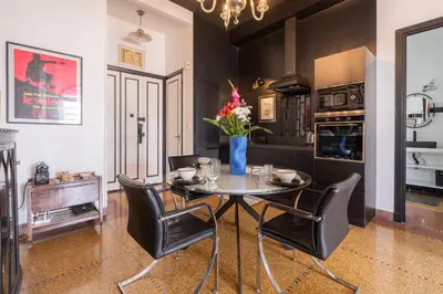 a dining room with a table and chairs and a kitchen at Assayag Art Deco - 1930 in Casablanca