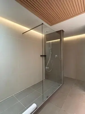 a shower with a glass door in a bathroom at LabelCapitale in Rabat
