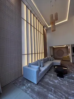 a living room with a couch and a large window at LabelCapitale in Rabat