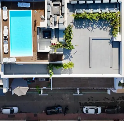 an overhead view of a building with a swimming pool at Luxury Warm-Wood Duplex - Rooftop Sky Pool Access in Casablanca