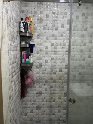a bathroom with a shower with a glass door at Appartement abwab tamaris in Dar Mouddene