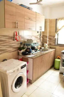 a kitchen with a washing machine and a sink at Havre de paix appartement in Mohammedia