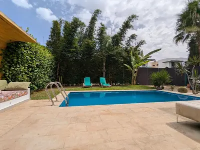a swimming pool in a yard with two blue chairs at Villa 3-bedroom with Private Pool in Tamaris in Tamaris