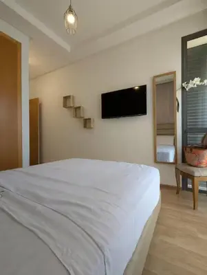a bedroom with a white bed and a flat screen tv at Villa 3-bedroom with Private Pool in Tamaris in Tamaris