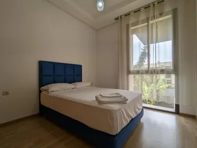 a bedroom with a bed with a blue headboard and a window at Villa 3-bedroom with Private Pool in Tamaris in Tamaris