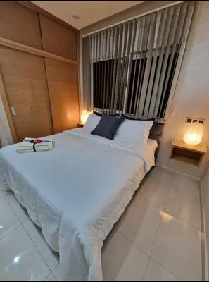 a large bed in a room with a large window at Appartement bien meublé in Rabat