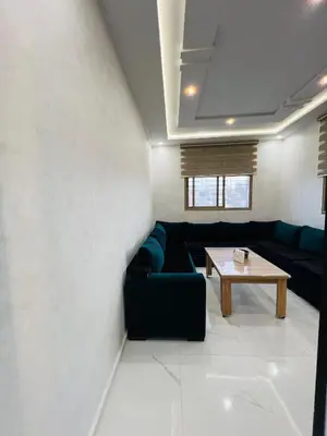 a living room with a couch and a table at Modern Apartment Bouznika in Bouznika