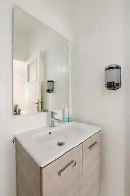 a bathroom with a sink and a large mirror at Modern 1 Bedroom W Terrace-Arribat Center in Rabat