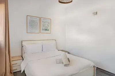 a bedroom with a white bed with two towels on it at Modern 1 Bedroom W Terrace-Arribat Center in Rabat