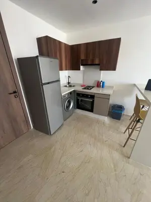 a kitchen with a refrigerator and a stove at Adam résidence in Casablanca