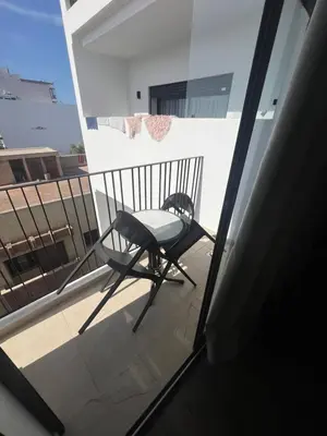 a chair sitting on a balcony with a view at Adam résidence in Casablanca