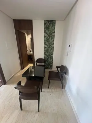 a living room with a table and chairs at Adam résidence in Casablanca