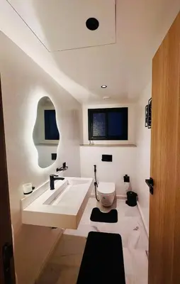a bathroom with a white tub and a toilet at Cozy Studio Steps from Med V Stadium in Casablanca
